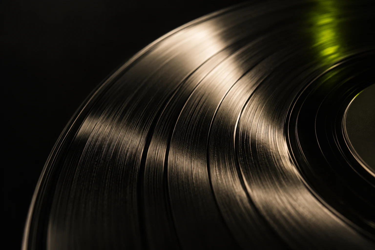 Sculptural grooves of a vinyl record illuminated by lime light